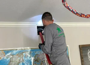 technician cleaning an air duct