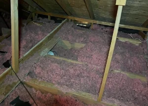 insulation being applied in an attic to enhance energy efficiency