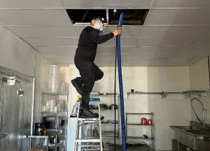 air duct cleaning specialist servicing a commercial HVAC system