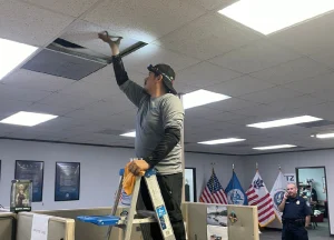 professional technician cleaning an air duct in a well-ventilated commercial space