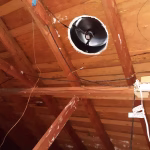 Interior view of solar attic fan operating inside attic