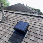 Solar attic fan installed on residential home roof