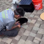 Top Star Air Pros technician mounting solar attic fan