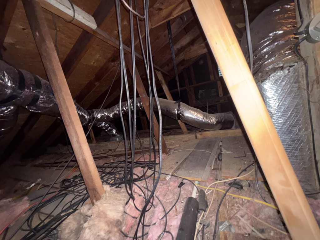 Old attic insulation and debris in Pasadena Texas home
